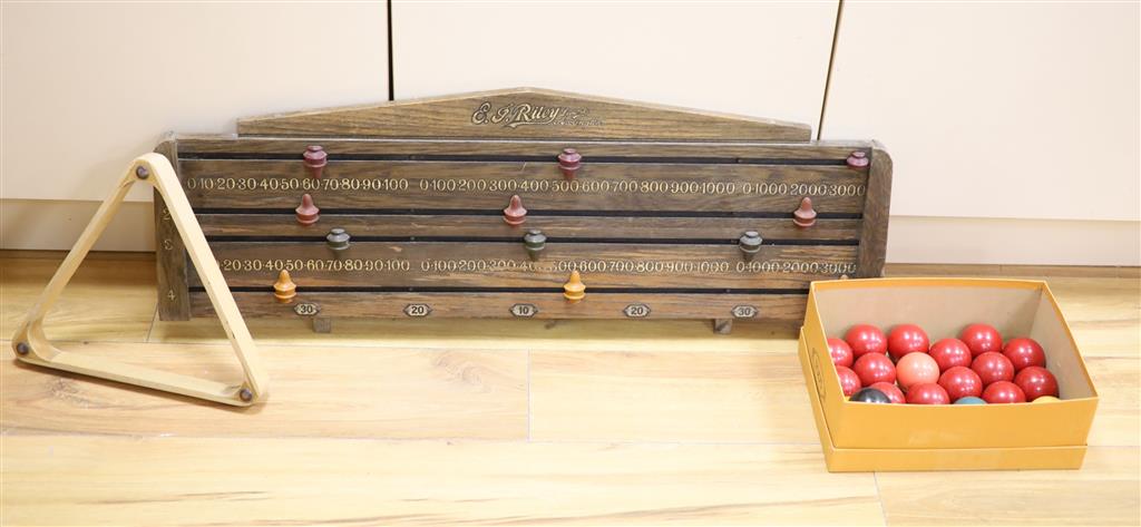 An E. J. Riley Ltd oak snooker score board and a set of snooker balls and a triangle